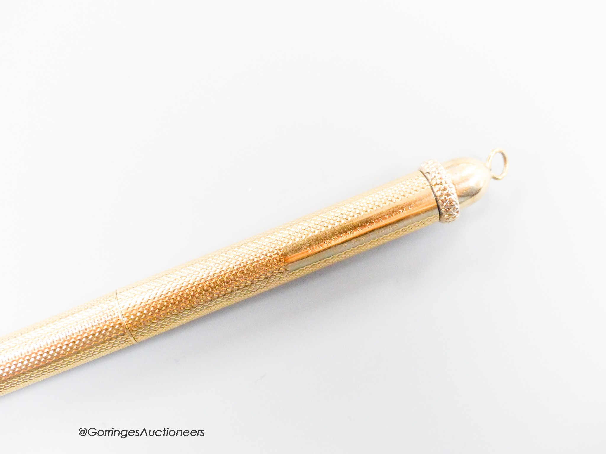 A 1960's engine turned 18k overlaid dip pen, with engraved inscription, 12.9cm, gross weight 24.4 grams.